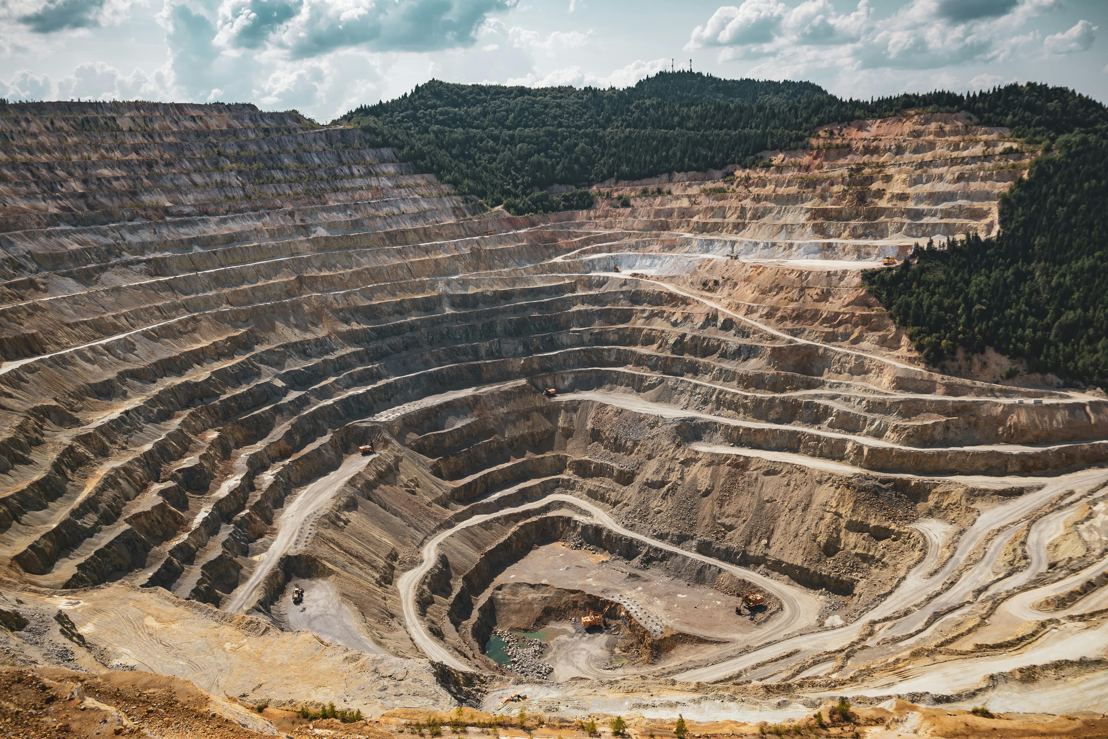Excavator operating in pit
