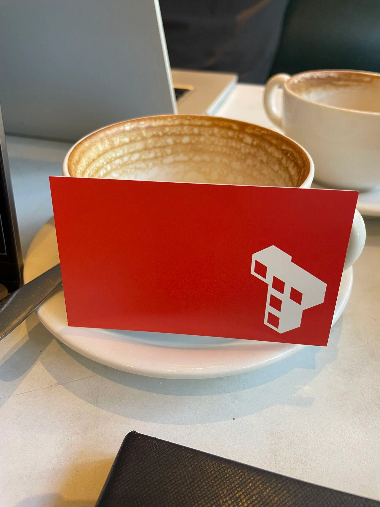 Terrabit business card resting on a coffee cup