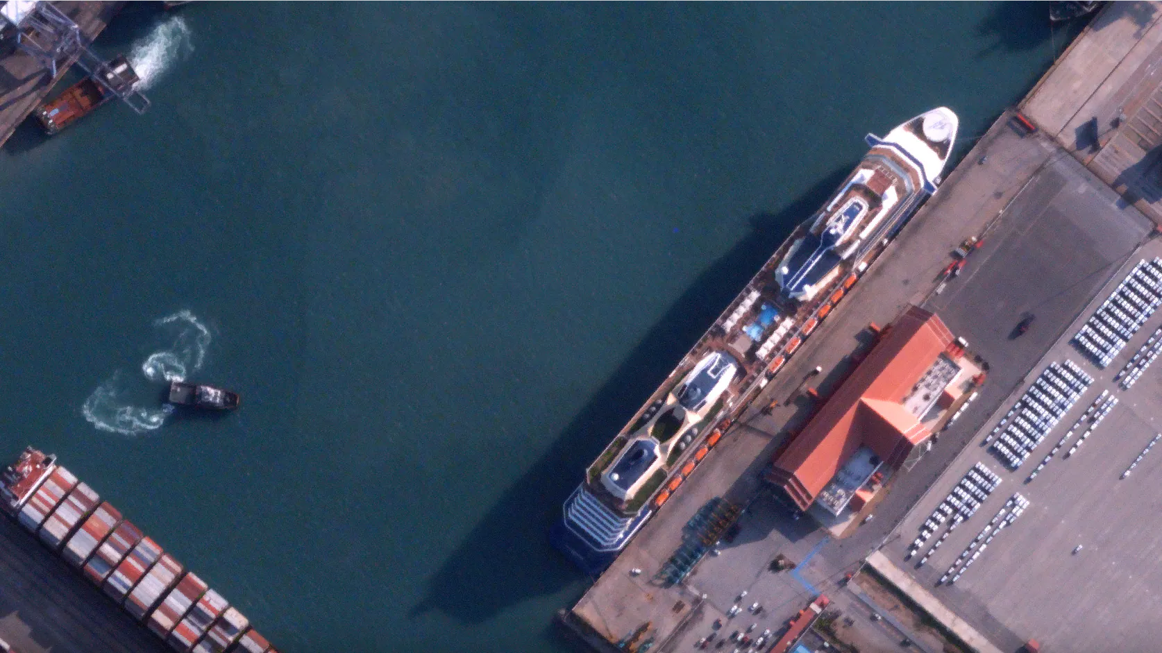 High res satellite image of a cruise ship berthed at Laem Chabang Port, Thailand