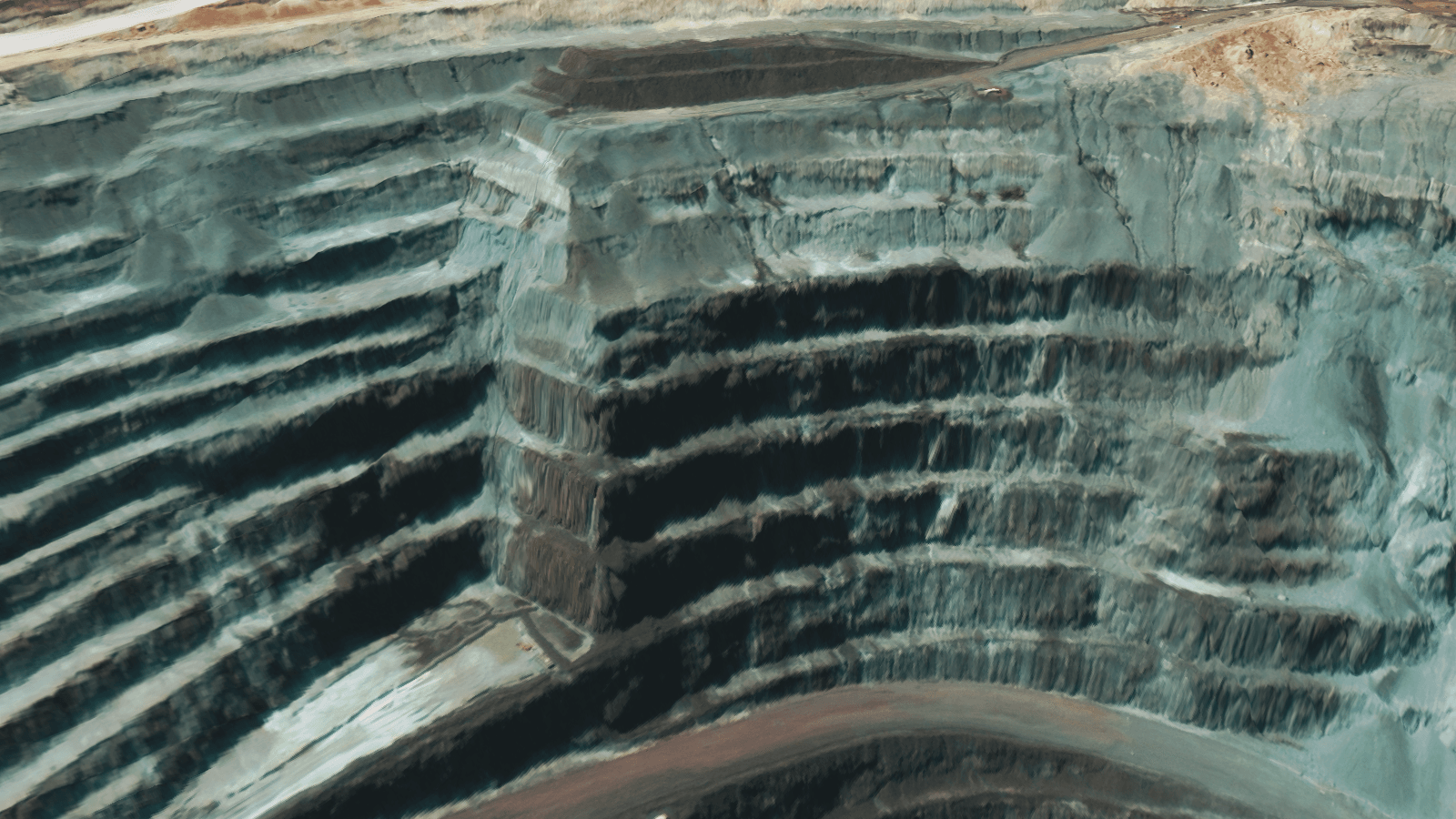 3D elevation model showing detailed mine pit wall geometry and bench structures.