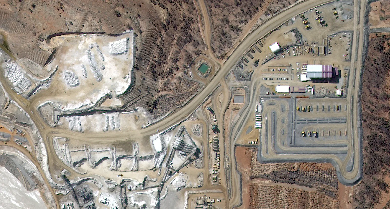 Mine operations area (2024) showing active traffic and surface condition.